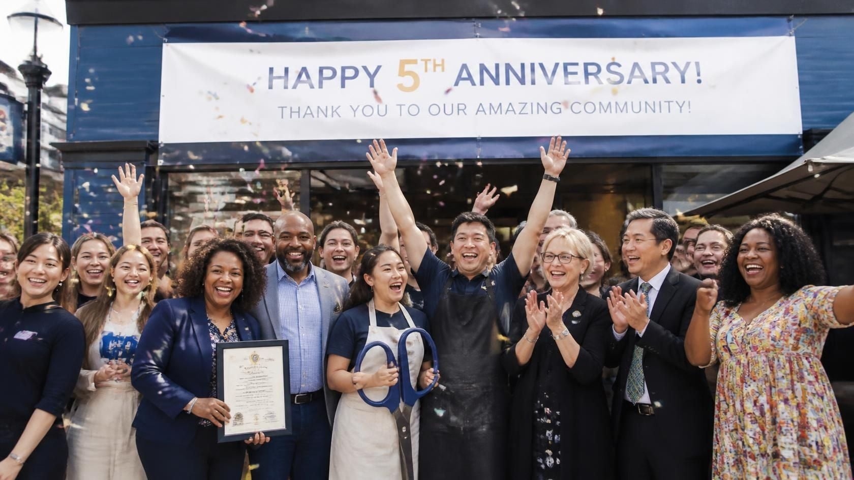 Diverse group celebrating business milestone..